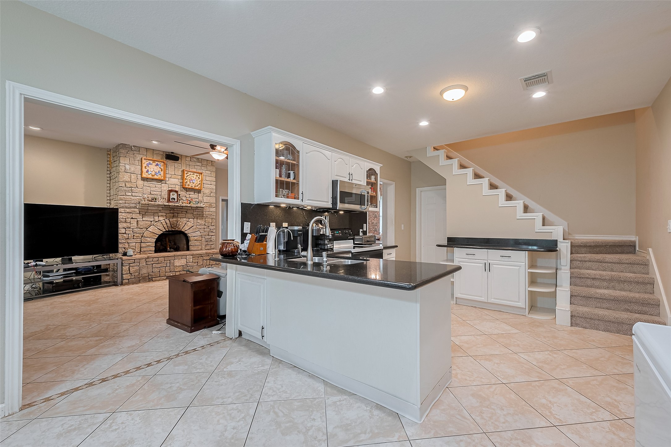 2499 Southline Road Conroe, TX 77384 - Photo 15 of 48 a living room with furniture a flat screen tv and a fireplace