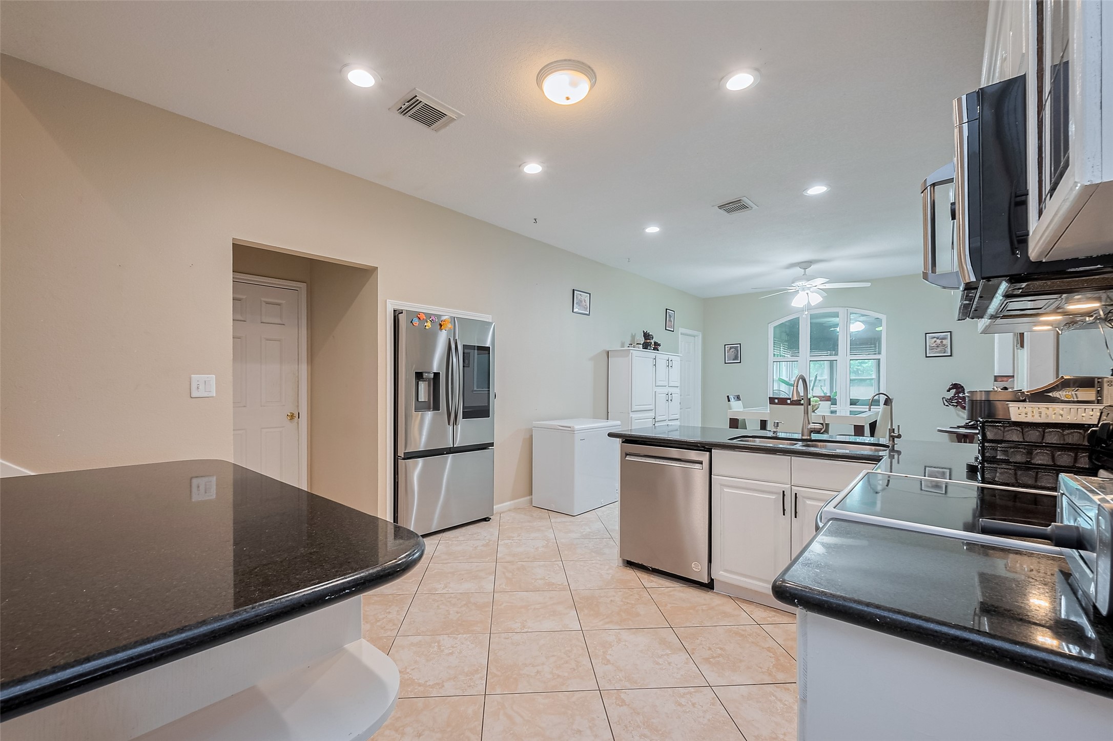 2499 Southline Road Conroe, TX 77384 - Photo 17 of 48 a kitchen with stainless steel appliances granite countertop a sink and a stove