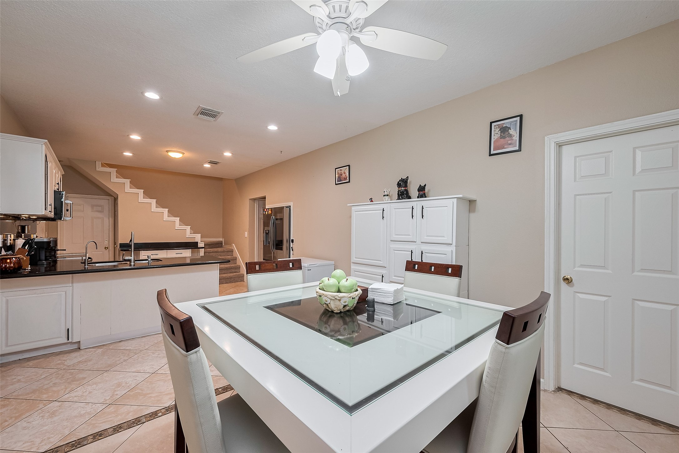 2499 Southline Road Conroe, TX 77384 - Photo 18 of 48 a kitchen with stainless steel appliances granite countertop a sink a stove a dining table and chairs