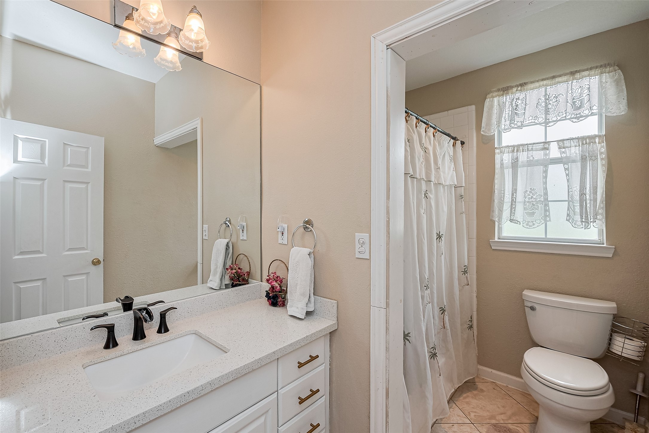 2499 Southline Road Conroe, TX 77384 - Photo 28 of 48 a bathroom with a toilet sink shower and mirror