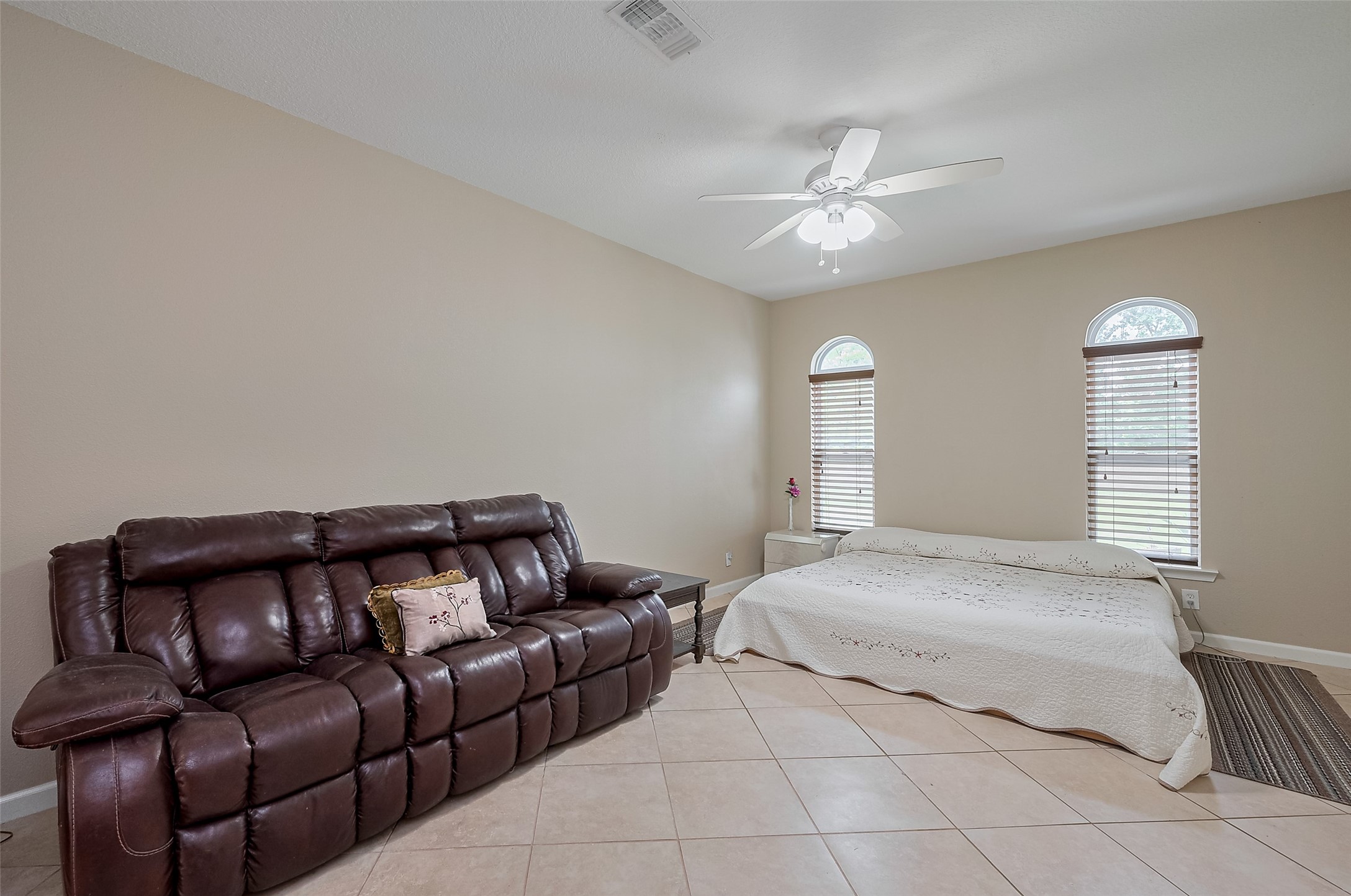 2499 Southline Road Conroe, TX 77384 - Photo 30 of 48 a bedroom with a bed couch and window