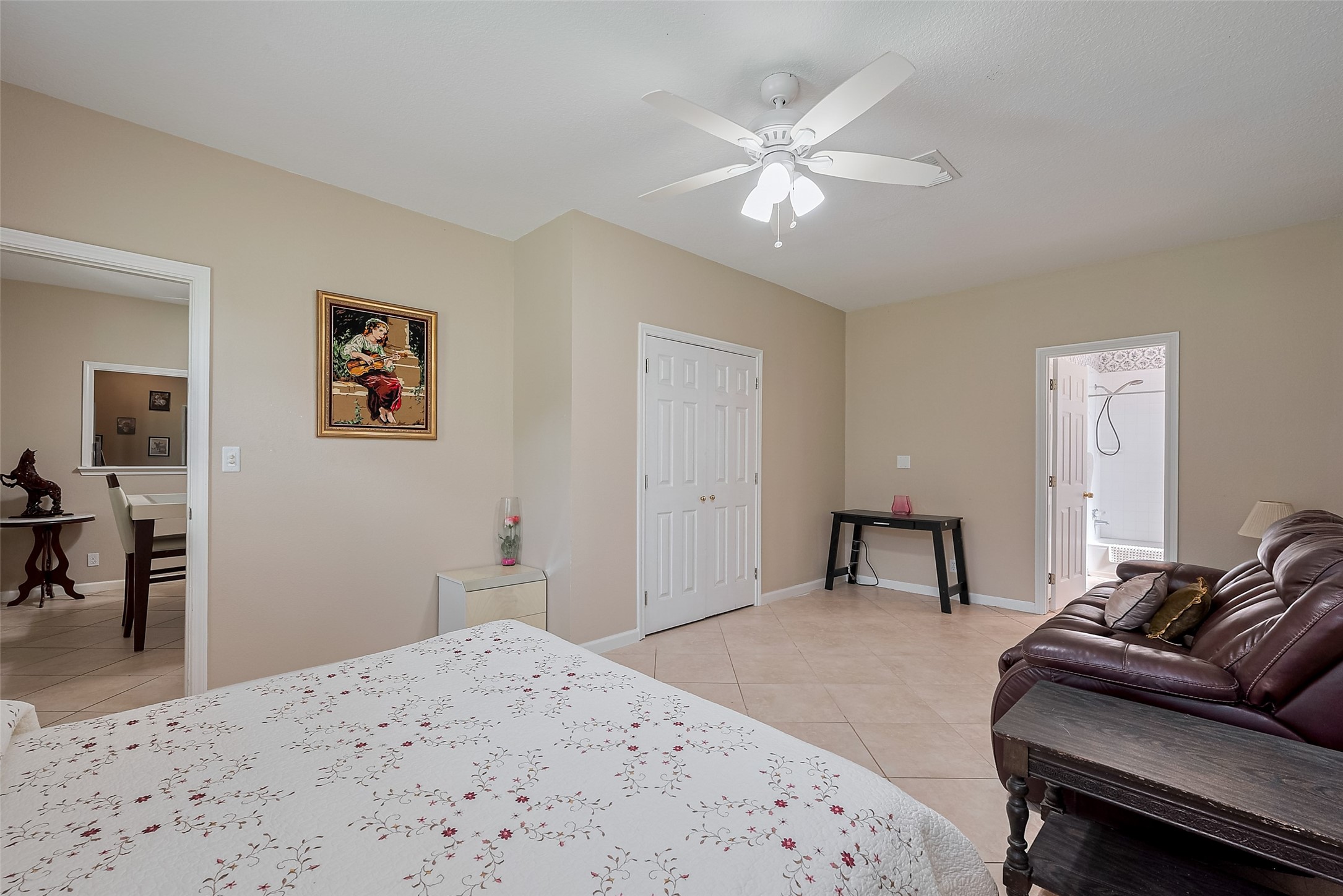 2499 Southline Road Conroe, TX 77384 - Photo 31 of 48 a bedroom with a bed and a chandelier