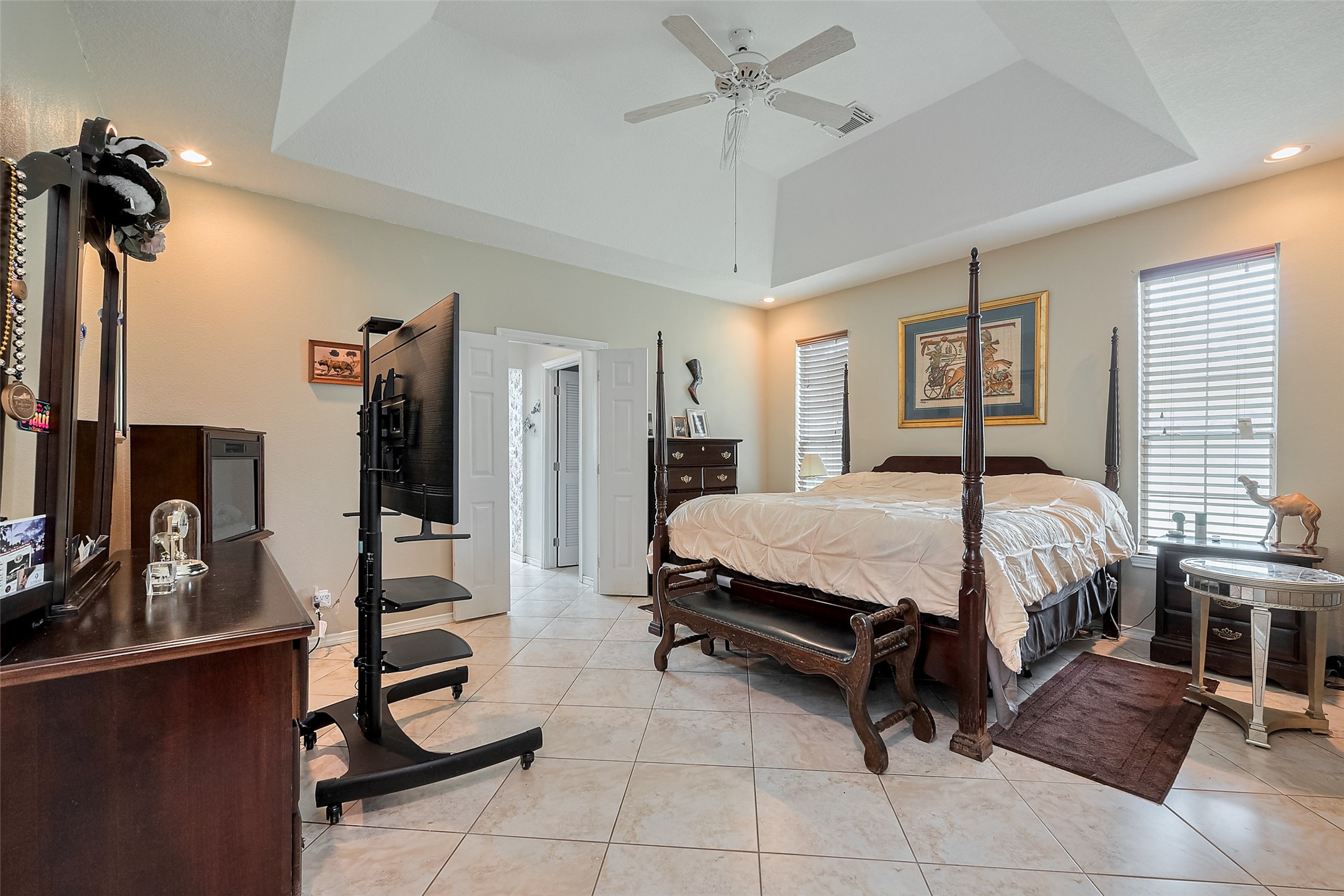 2499 Southline Road Conroe, TX 77384 - Photo 35 of 48 a bedroom with a bed a dresser and mirror