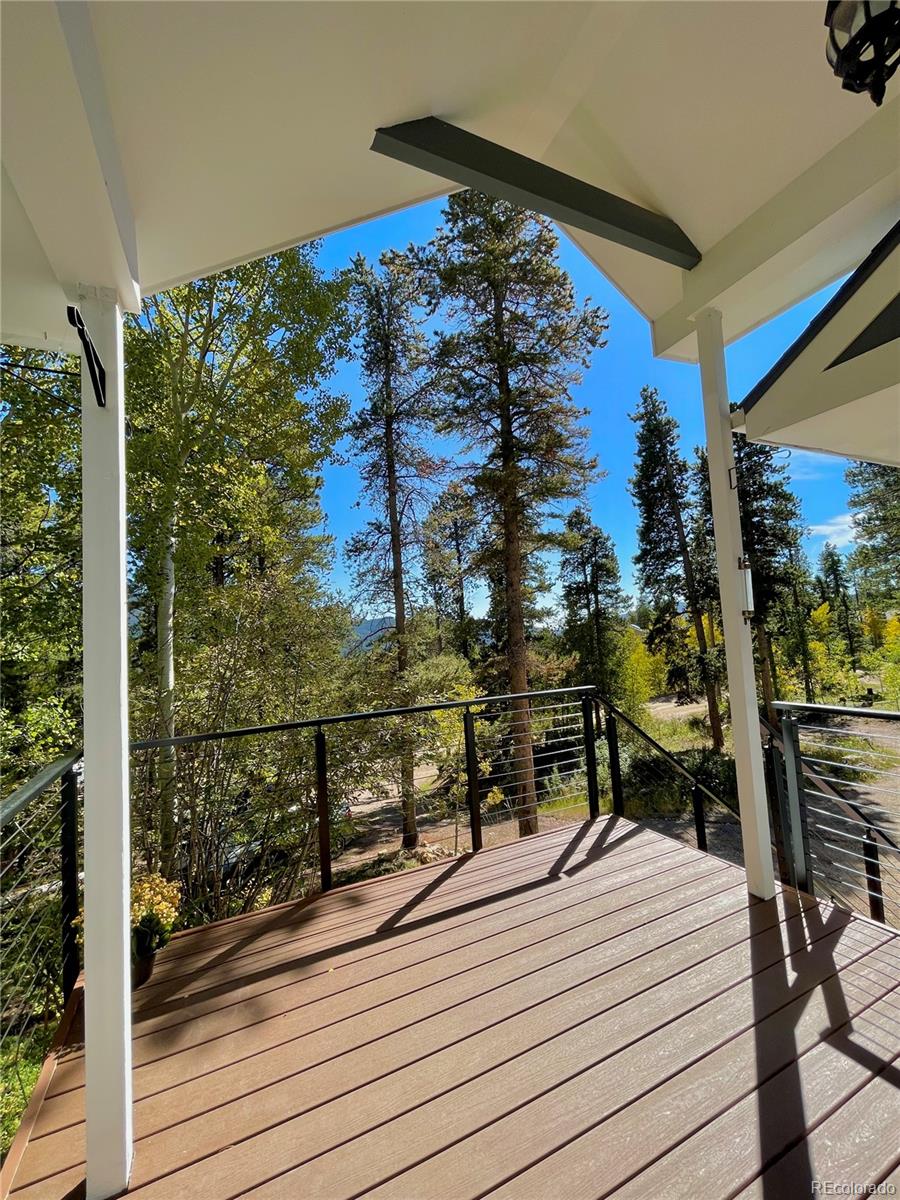 265 Caesar Road Black Hawk, CO 80422 - Photo 8 of 42 a view of a balcony with wooden floor and bench