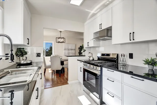 a living room with fireplace furniture and a potted plant