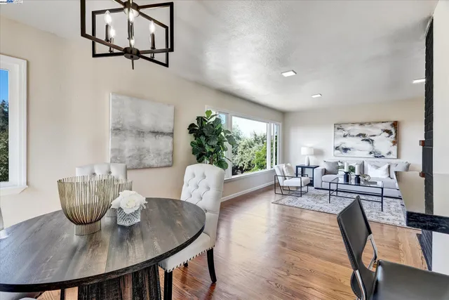 a view of a dining room with furniture window and wooden floor