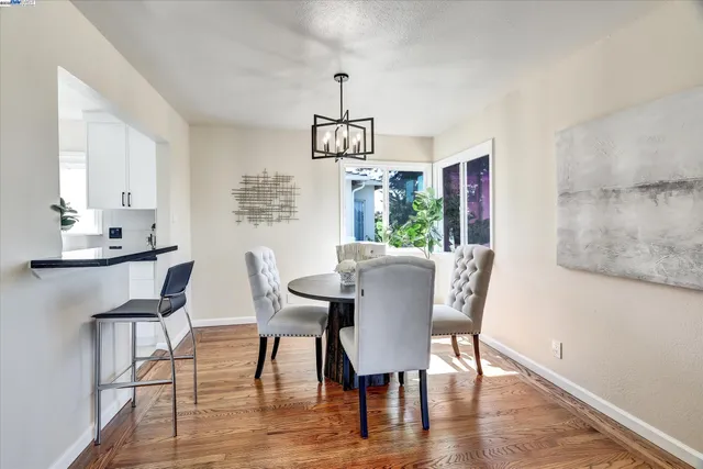a living room with furniture potted plant a fireplace and a large window