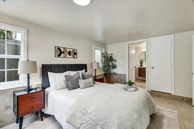 a bedroom with a bed and a couch