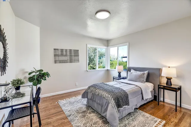 a bedroom with a bed and a potted plant