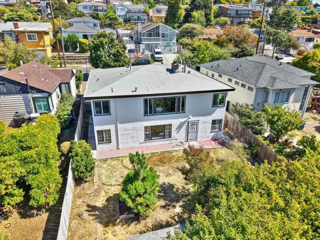 an aerial view of a house with a yard and a fountain