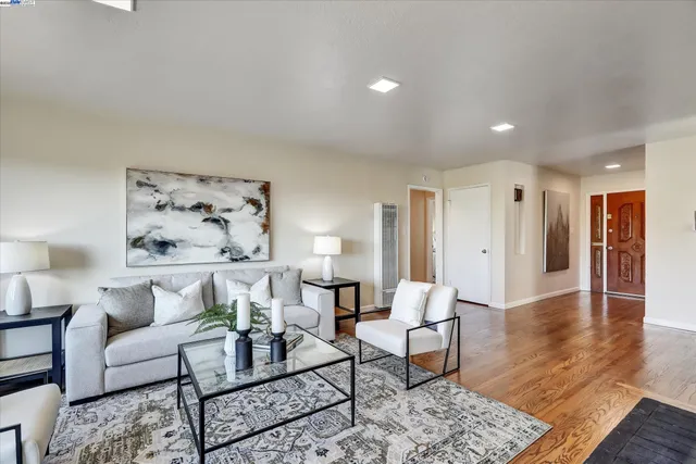 a living room with fireplace furniture and a wooden floor