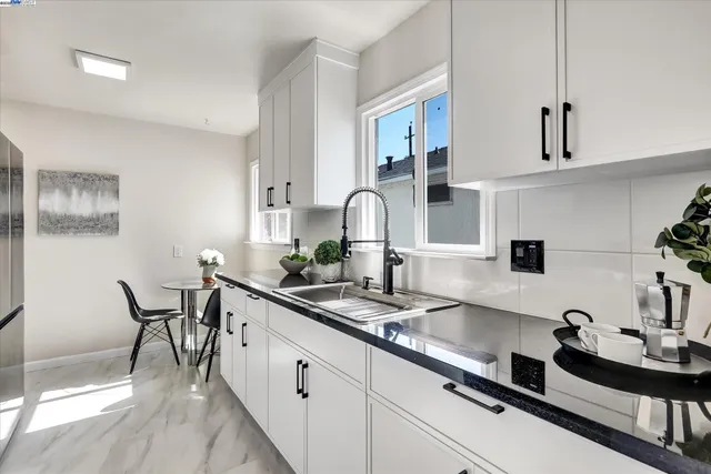 a kitchen with stainless steel appliances a sink and a stove