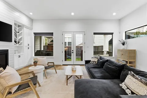 a view of a patio with couches table and chairs with wooden floor and fence