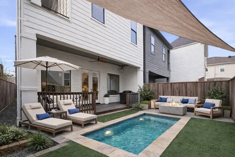 a view of a house with a deck and furniture