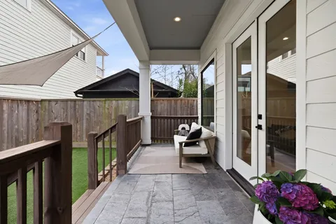 a kitchen with stainless steel appliances a dining table chairs and wooden floor