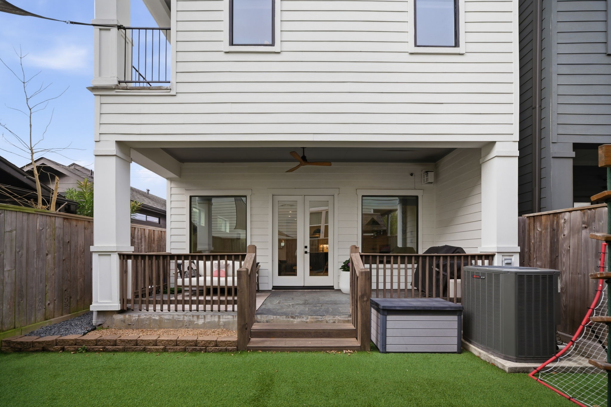 504 Oxford Street Houston, TX 77007 - Photo 15 of 47 The rear elevation highlights the covered patio and second-story balcony above. Clean siding lines and thoughtful proportions reflect the home’s 2020 construction. It’s a private backyard setting that complements the home’s overall design.
