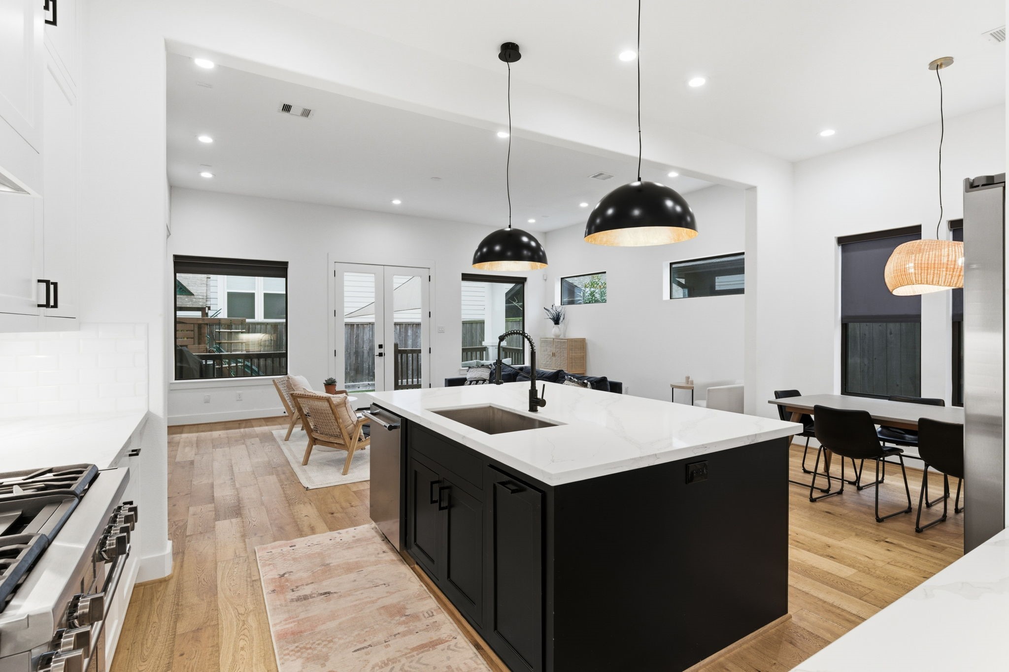 504 Oxford Street Houston, TX 77007 - Photo 19 of 47 From the kitchen, sightlines extend across the dining and living areas, reinforcing the open-concept design. The layout makes it easy to stay connected whether cooking, hosting, or relaxing. Natural light fills the space from the rear windows and doors.