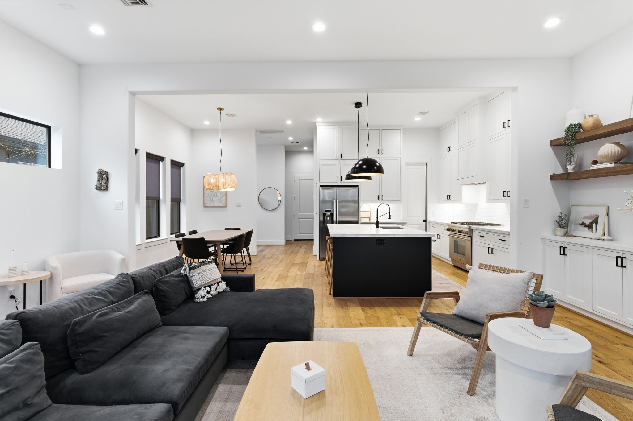 504 Oxford Street Houston, TX 77007 - Photo 20 of 47 The entire first floor connects effortlessly from living to dining to kitchen. High ceilings and recessed lighting enhance the sense of openness. It’s a layout that balances everyday comfort with entertaining potential.