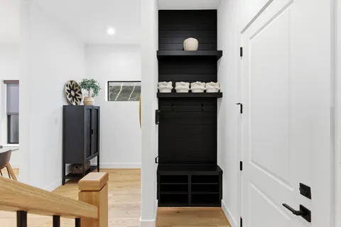 a view of a hallway with wooden cabinets
