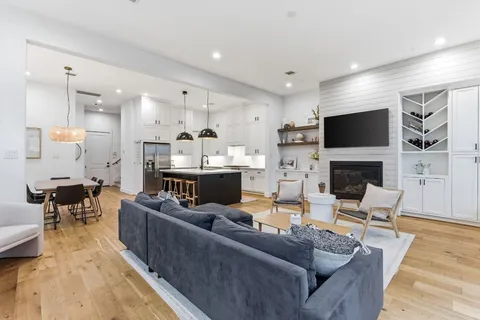 a kitchen with stainless steel appliances a sink a stove and white cabinets