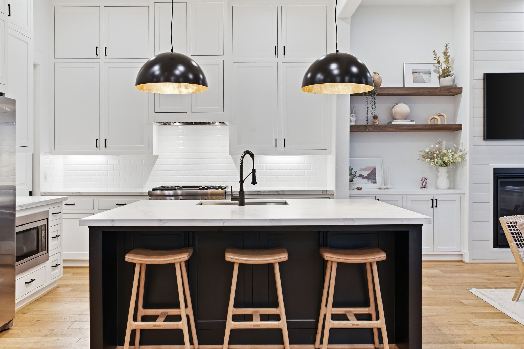 504 Oxford Street Houston, TX 77007 - Photo 6 of 47 The oversized island anchors the kitchen with generous prep space and seating. Quartz countertops, contrasting cabinetry, and statement pendant lighting create a clean yet inviting focal point. It’s designed for both casual mornings and effortless entertaining.