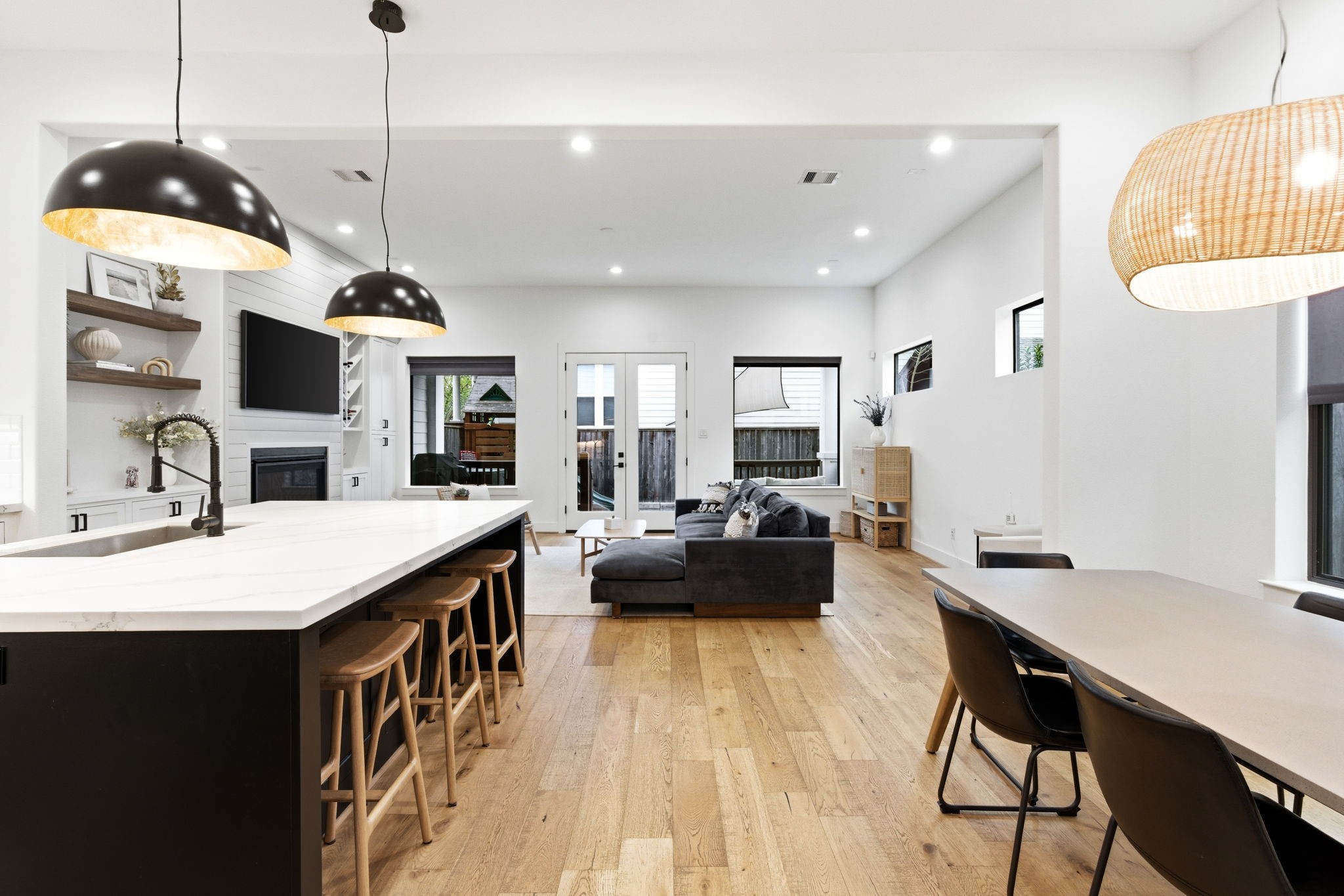 504 Oxford Street Houston, TX 77007 - Photo 8 of 47 The heart of the home opens into a spacious layout connecting the kitchen, dining, and living areas. High ceilings and recessed lighting enhance the sense of space. Large windows bring in natural light throughout the day.