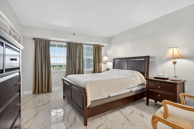 a bedroom with a bed and a lamp on table