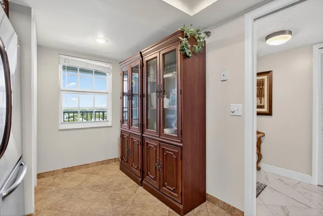 a view of a hallway with windows and closet