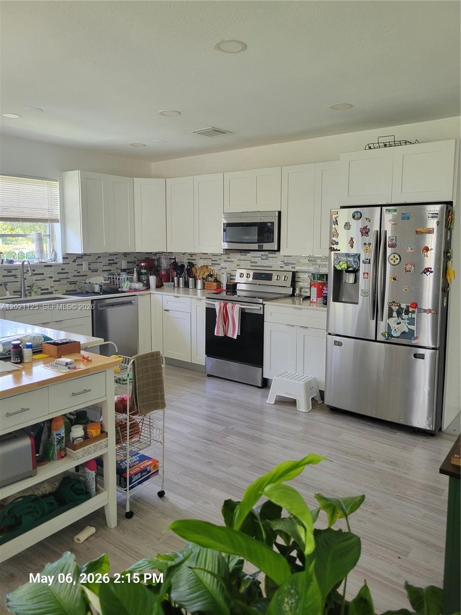 13220 Southwest 99th Place Miami, FL 33176 - Photo 2 of 16 a kitchen with refrigerator and microwave
