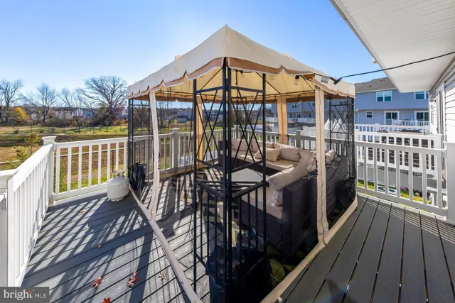 a view of a balcony with wooden floor and outdoor seating
