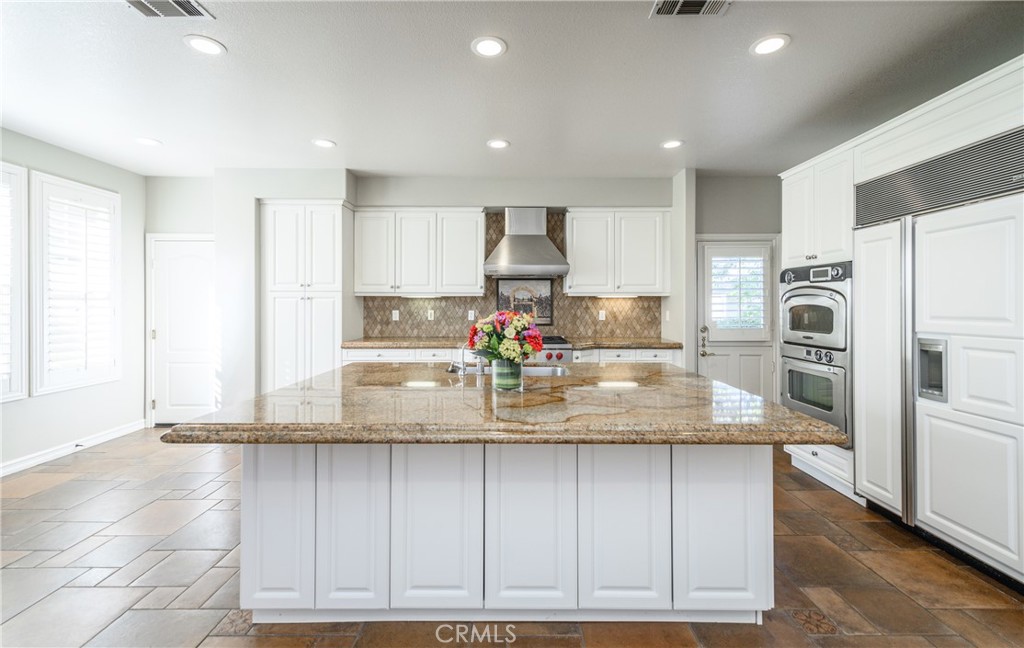 2 Bayleaf Lane Irvine, CA 92620 - Photo 18 of 40 a kitchen with stainless steel appliances granite countertop a sink and a refrigerator