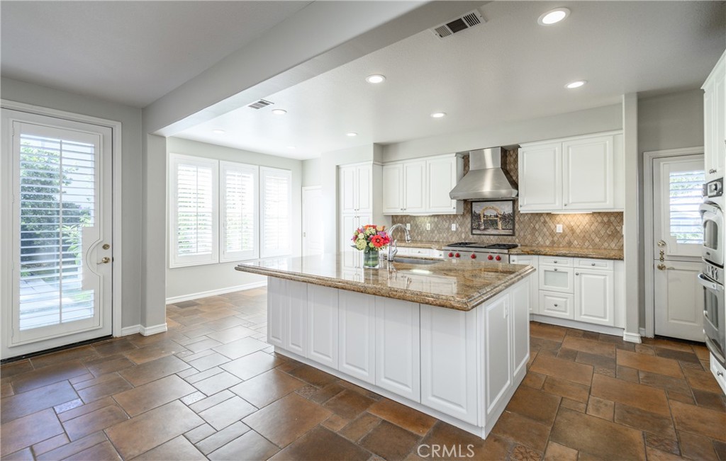 2 Bayleaf Lane Irvine, CA 92620 - Photo 19 of 40 a kitchen with kitchen island granite countertop a stove and a sink