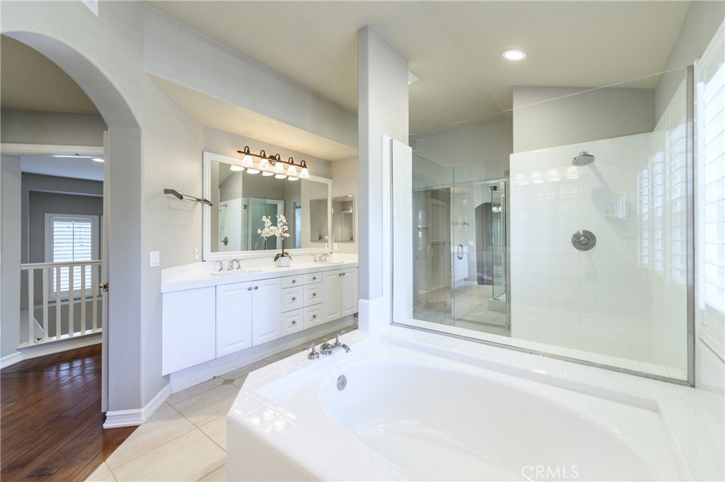 2 Bayleaf Lane Irvine, CA 92620 - Photo 28 of 40 a bathroom with a tub a sink shower and mirror
