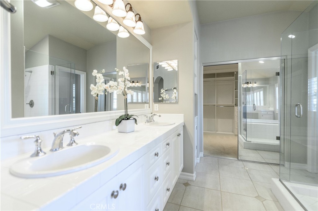 2 Bayleaf Lane Irvine, CA 92620 - Photo 29 of 40 a bathroom with a sink a large mirror and a shower