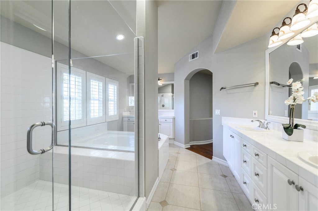 2 Bayleaf Lane Irvine, CA 92620 - Photo 30 of 40 a spacious bathroom with a shower sink and mirror