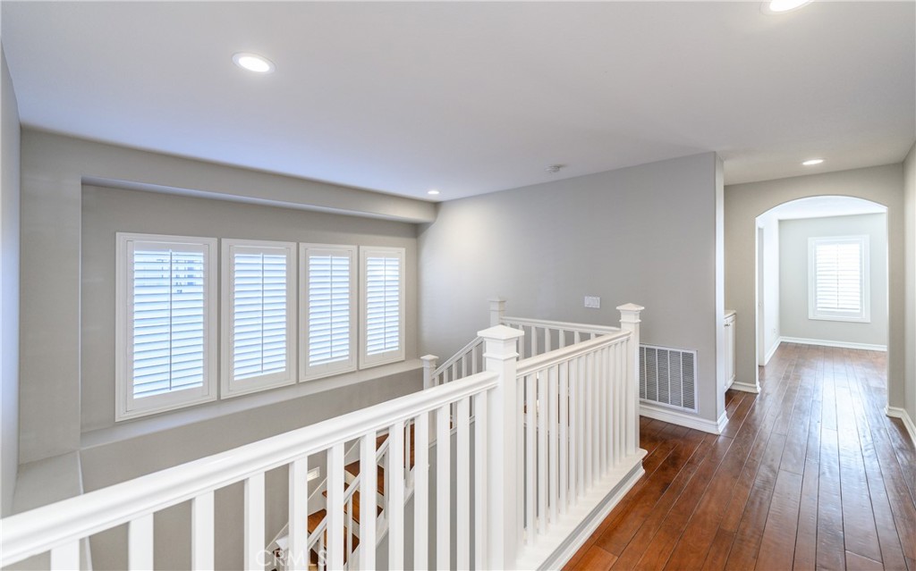 2 Bayleaf Lane Irvine, CA 92620 - Photo 32 of 40 a view of a hallway with wooden floor and stairs