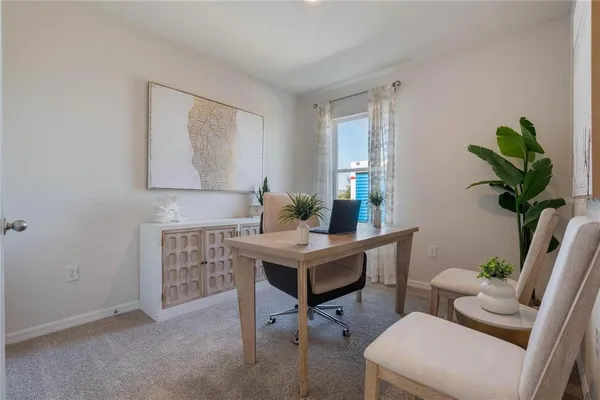 a view of a workspace with furniture and a potted plant