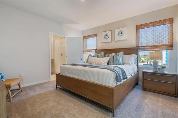 a spacious bedroom with a bed and window