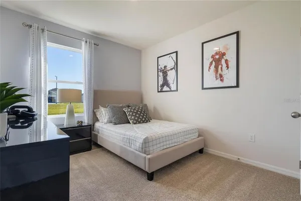 a bedroom with a bed and a large window