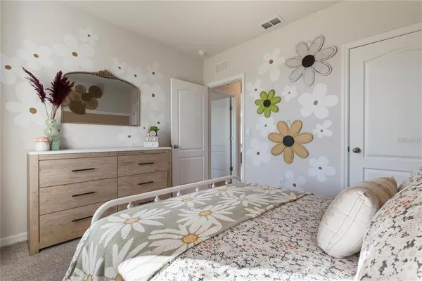 a bedroom with a bed and a dresser