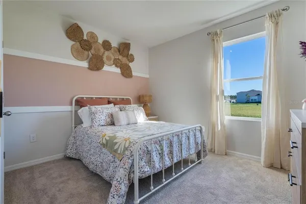 a bedroom with a bed and window