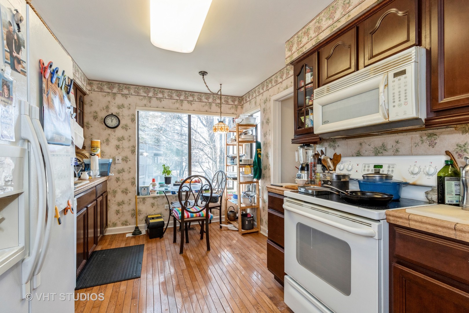 70 Cedar Ridge, Unit C Lake Barrington, IL 60010 - Photo 5 of 18 a view of a kitchen with furniture and wooden floor