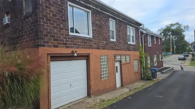 a front view of a house with garage