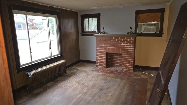 a view of an empty room and wooden floor