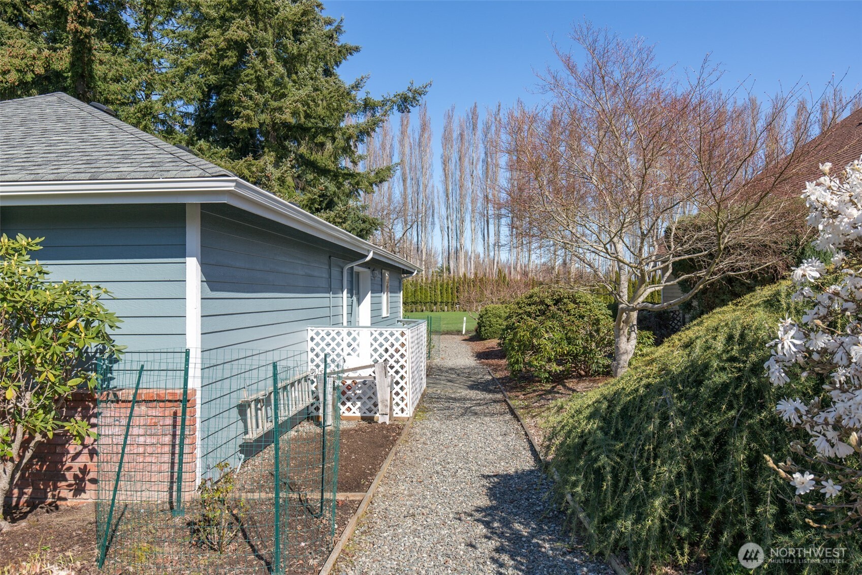 170 Hurricane Ridge Drive Sequim, WA 98382 - Photo 6 of 39 a view of a wooden house with a yard