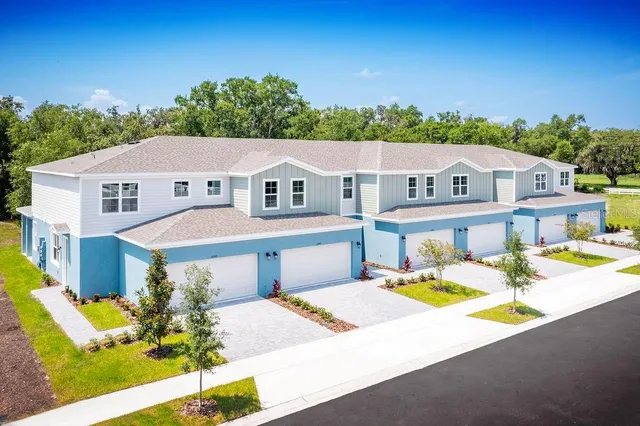 a view of a house with pool and chairs