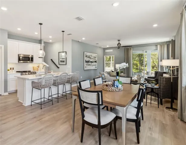 a view of a dining room with furniture window and wooden floor