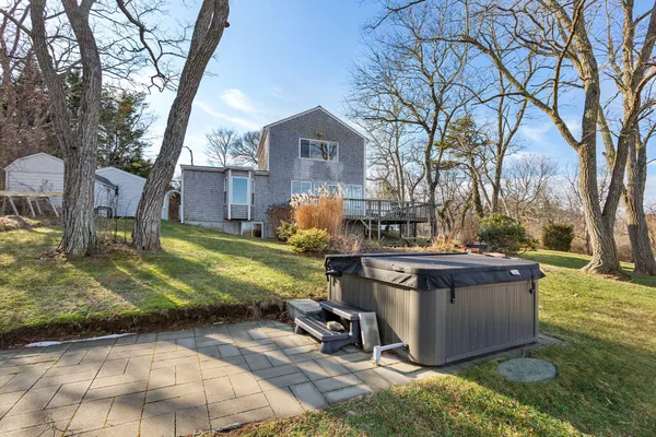 a view of a house with wooden deck and furniture