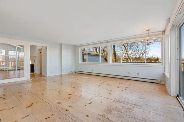 wooden floor in an empty room with a window