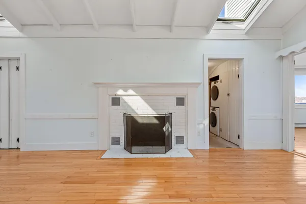 a view of empty room with wooden floor